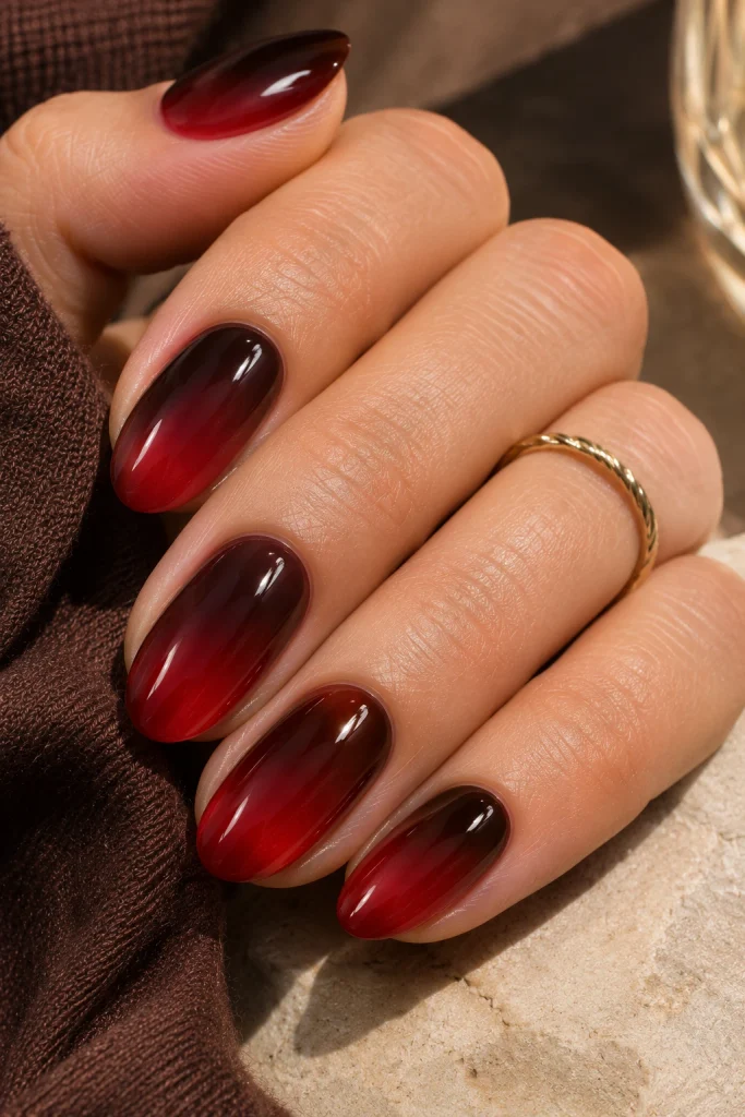  Glossy cherry cola ombré nails blending deep brown into dark cherry red.